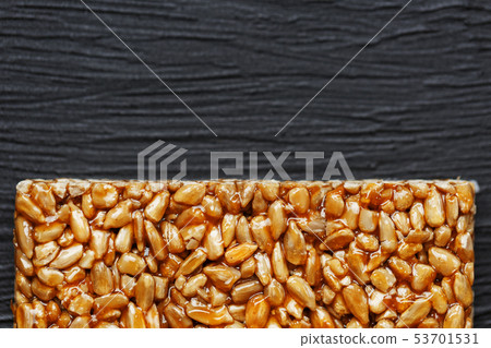 Tile kozinaki from sunflower seeds on a black Tile kozinaki from sunflower seeds on a black 53701531