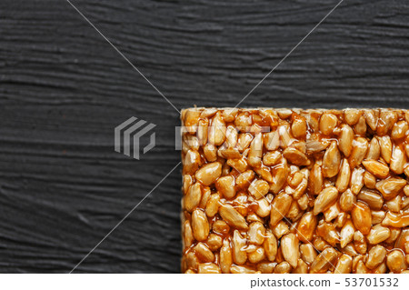 Tile kozinaki from sunflower seeds on a black Tile kozinaki from sunflower seeds on a black 53701532