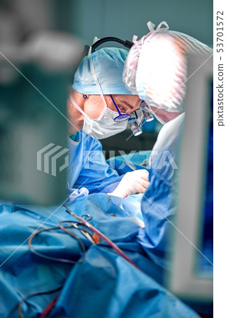 Close-up of an operating surgery team. A team of surgeons professionals with assistants in the 53701572