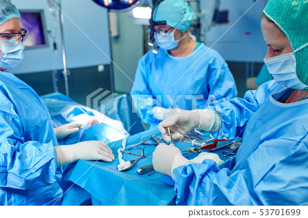 Close-up of an operating surgery team. A team of surgeons professionals with assistants in the 53701699