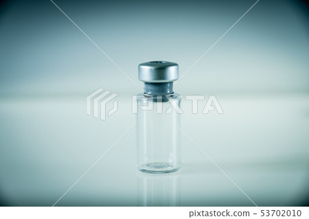 Vaccine bottle on grey background Vaccine bottle on grey background 53702010