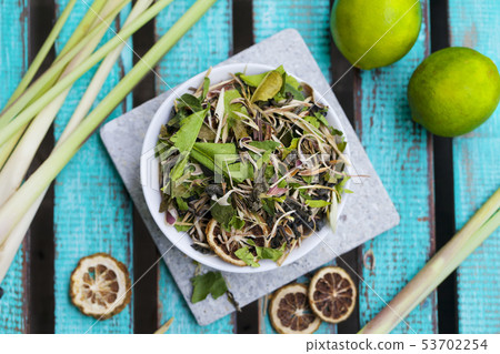 Lemongrass, lime, herbal tea ingredients on blue wooden background. Top view. Lemongrass, lime, herbal tea ingredients on blue wooden background. Top view. 53702254