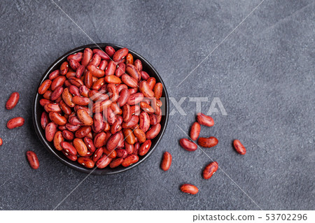 Red lentil in a black bowl on grey stone background. Top view. Copy space. Red lentil in a black bowl on grey stone background. Top view. Copy space. 53702296