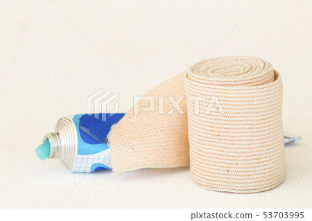 topical medication with roll bandage for first aid 53703995