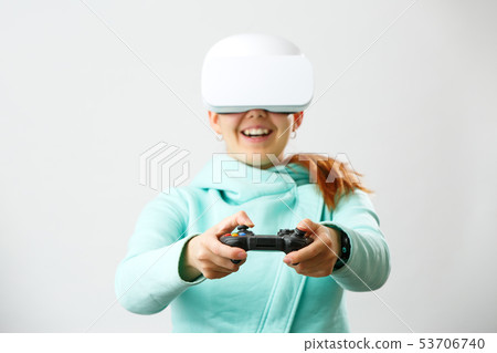 Woman with virtual reality headset is playing game. 53706740