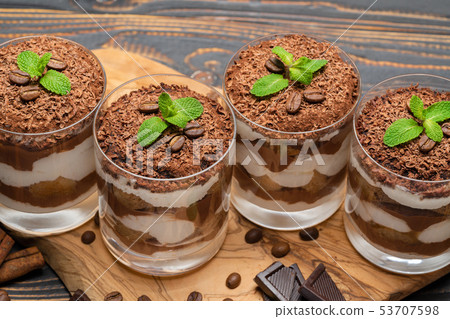 Classic tiramisu dessert in a glass on wooden background Classic tiramisu dessert in a glass on wooden background 53707598