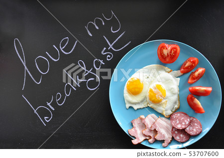 Colorful breakfast on the blue plate with text on Colorful breakfast on the blue plate with text on 53707600