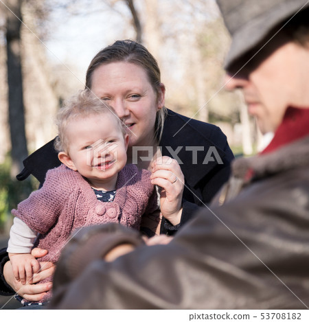 Young family with cheerful child in the park. Young family with cheerful child in the park. 53708182