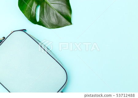 Blue feminine handbag on blue background. Blue feminine handbag on blue background. 53712488