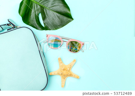 Blue feminine handbag on blue background. Flat lay 53712489