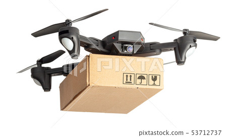 Drone with a cardboard box makes delivery by air. Drone with a camera carries postal parcel. Drone with a cardboard box makes delivery by air. Drone with a camera carries postal parcel. 53712737