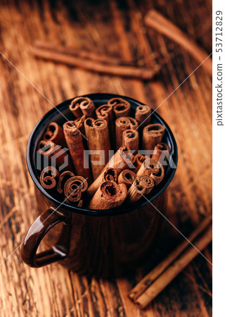 Cinnamon sticks in a metal mugr Cinnamon sticks in a metal mugr 53712829