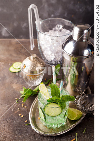 Detox infused cucumber water. Refreshing summer homemade cocktail on stone background Detox infused cucumber water. Refreshing summer homemade cocktail on stone background 53714562