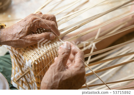 Senior man hands manually weaving bamboo. 53715892