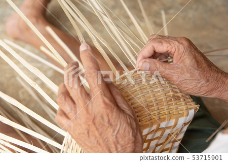 Senior man hands manually weaving bamboo. Senior man hands manually weaving bamboo. 53715901