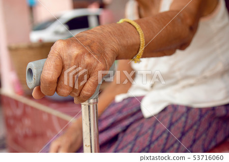 hands of old woman asia with a cane walking stick hands of old woman asia with a cane walking stick 53716060