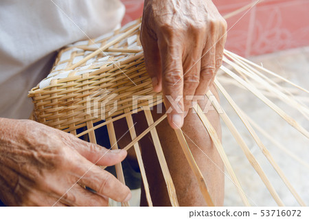 Senior man hands manually weaving bamboo. Senior man hands manually weaving bamboo. 53716072