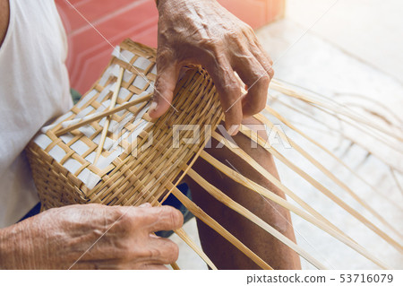 Senior man hands manually weaving bamboo. Senior man hands manually weaving bamboo. 53716079
