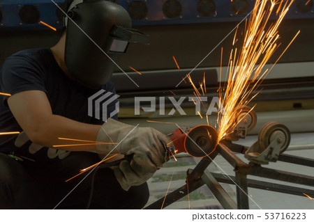 Electric wheel grinding cuting on steel. sparks 53716223