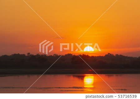 Sunset in the lake. beautiful sunset behind the 53716539