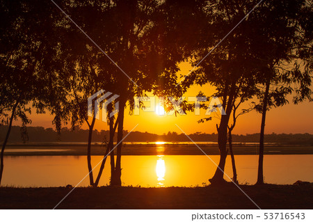 Sunset light rays piercing through the trees on Sunset light rays piercing through the trees on 53716543