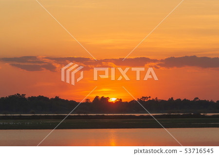 Sunset in the lake. beautiful sunset behind the 53716545