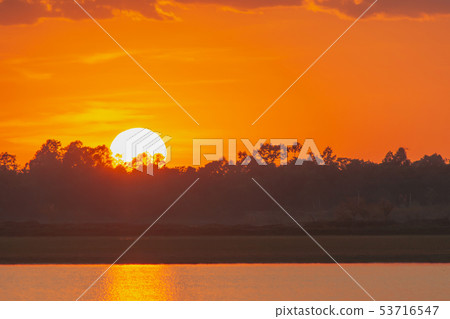Sunset in the lake. beautiful sunset behind the 53716547