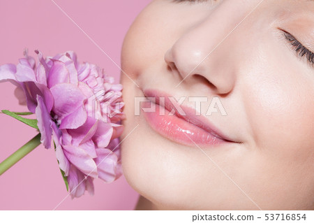 Young beautiful woman with flower on pink Young beautiful woman with flower on pink 53716854