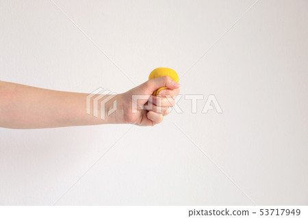 Hand press yellow squishy ball for exercise muscle 53717949