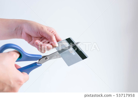 woman cutting a credit card for stop making owe. woman cutting a credit card for stop making owe. 53717958