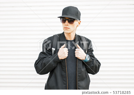 Handsome man with black glasses, a cap, a jacket Handsome man with black glasses, a cap, a jacket 53718285