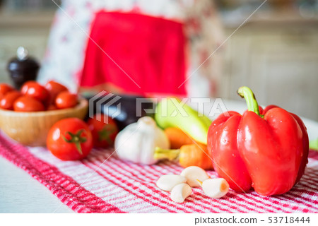 Fresh seasonal vegetables on kitchen table ready for cooking Fresh seasonal vegetables on kitchen table ready for cooking 53718444