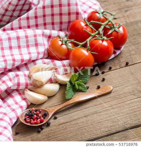 Tomatoes, mint, garlic and pepper on dark wood and Tomatoes, mint, garlic and pepper on dark wood and 53718976