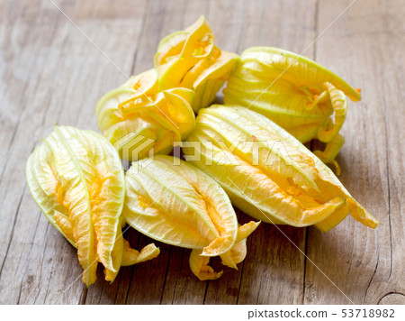 Flowers of zucchini on old wooden table Flowers of zucchini on old wooden table 53718982