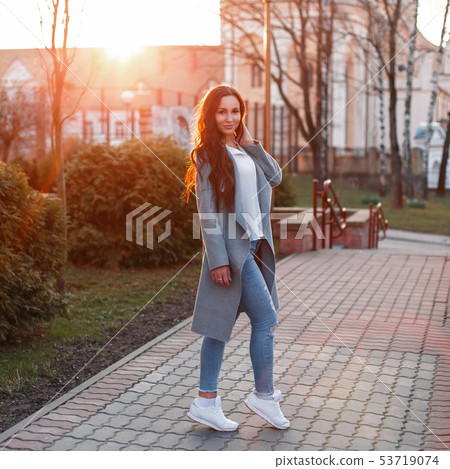 Stylish beautiful young woman in trendy gray coat 53719074