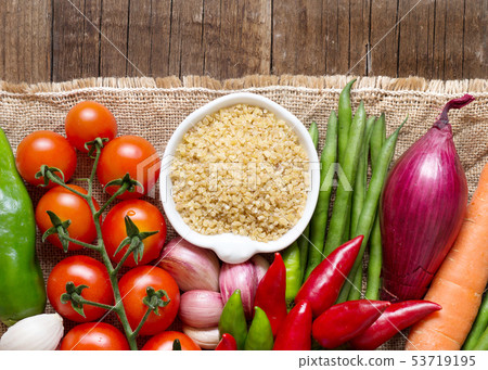 Raw Organic bulgur in bowl and vegetables Raw Organic bulgur in bowl and vegetables 53719195