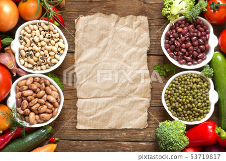 Legumes in bowls and vegetables 53719817