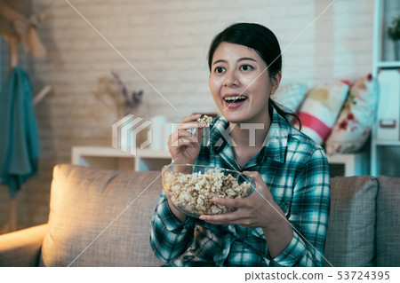 woman home alone watching television smiling 53724395