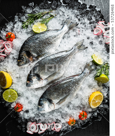 Fresh raw dorado fish and food ingredients on table Fresh raw dorado fish and food ingredients on table 53726468