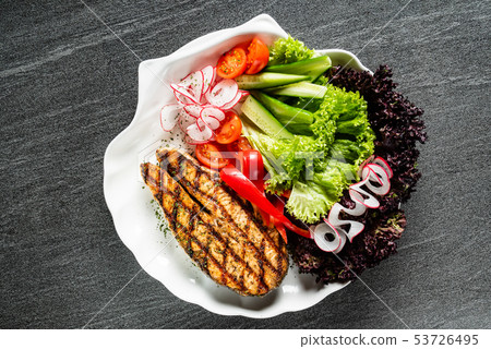 grilled salmon steak with fresh vegetables 53726495
