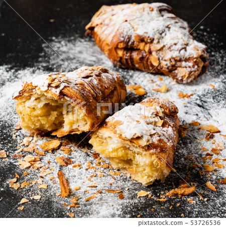 Croissants with almonds on the black background 53726536