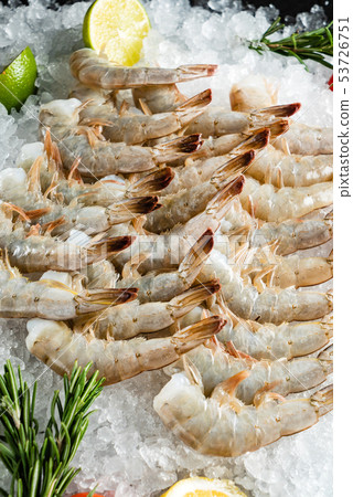 raw shrimps with lime and rosemary on the ice 53726751