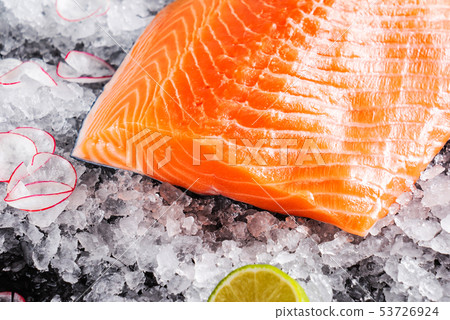 Raw salmon filet on the ice 53726924