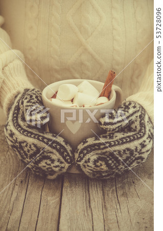 Hands in mittens holding hot chocolate Hands in mittens holding hot chocolate 53728096