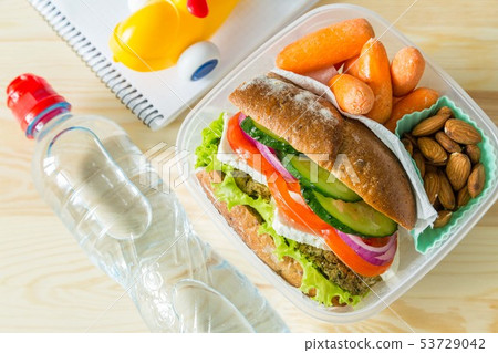 Vegan sandwich in lunch box with carrots and nuts 53729042