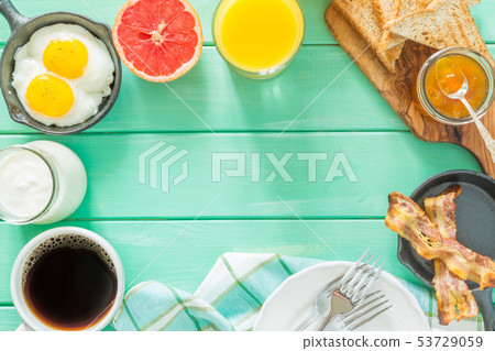 Summer breakfast - eggs, bacon, toast, jam, coffee, juice Summer breakfast - eggs, bacon, toast, jam, coffee, juice 53729059