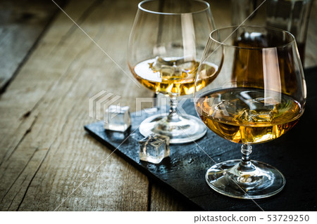 Cognac in glasses on rustic backgrpund Cognac in glasses on rustic backgrpund 53729250
