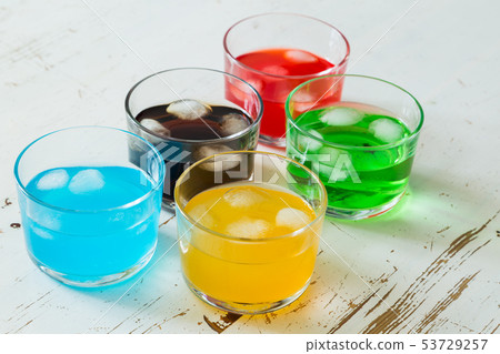 Selection of colorful drinks on white wood background Selection of colorful drinks on white wood background 53729257