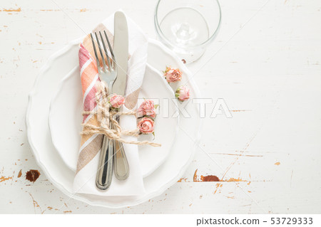 Romantic table setting with died flowers 53729333