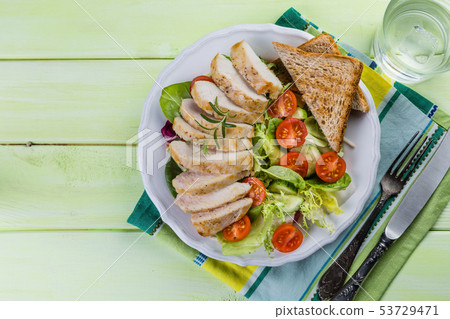 Salad with chicken steak on white plate 53729471